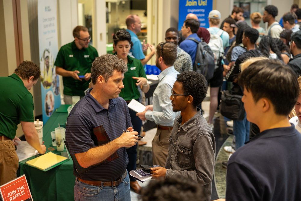student talking to company representative at career fair